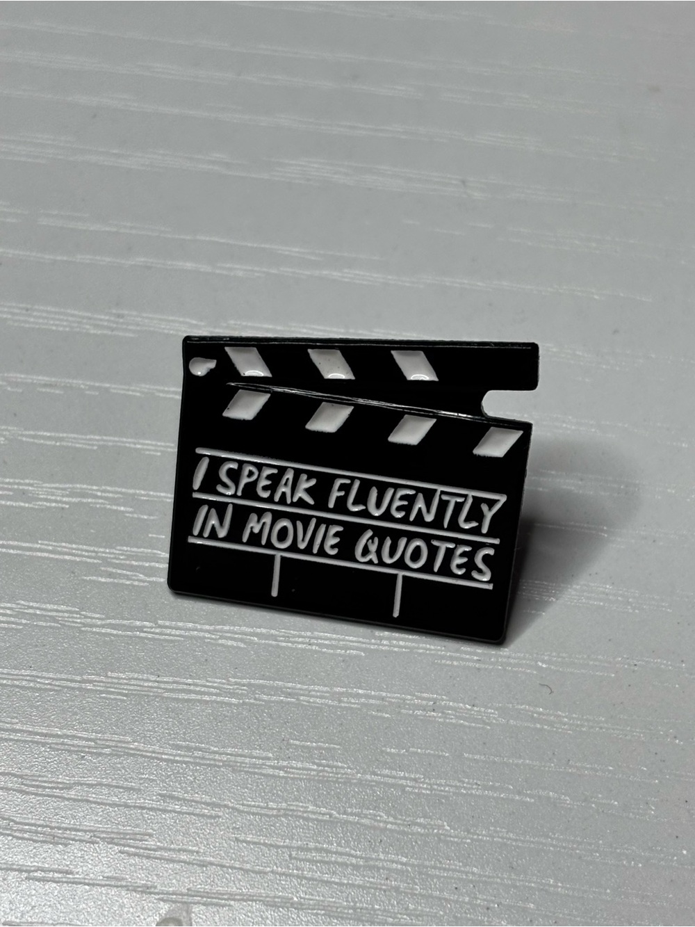 Clapperboard Enamel Pin - "I Speak Fluently in Movie Quotes" - Black & White